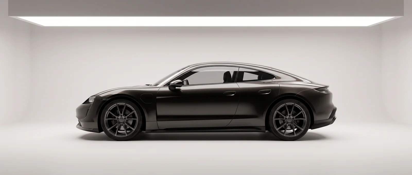 An unbadged electric coupe in a white studio cove under strip lights